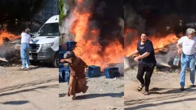 Otluk alandaki çöp yangınına kovalarla su dökerek müdahale eden mahalleli,